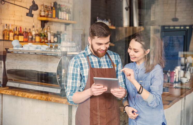 Restaurant workers handling reservations online Restaurant workers handling reservations online