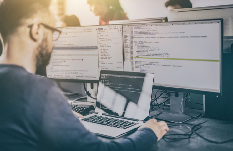 Man coding in order to build a website Man coding in order to build a website