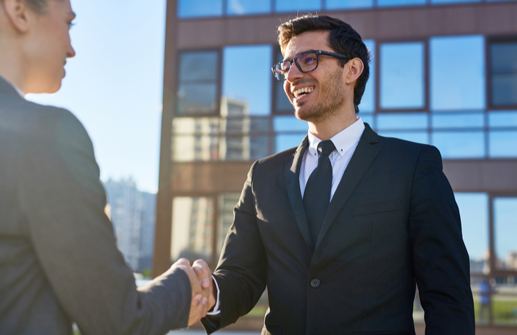 Businessman greeting businesswoman Businessman greeting businesswoman