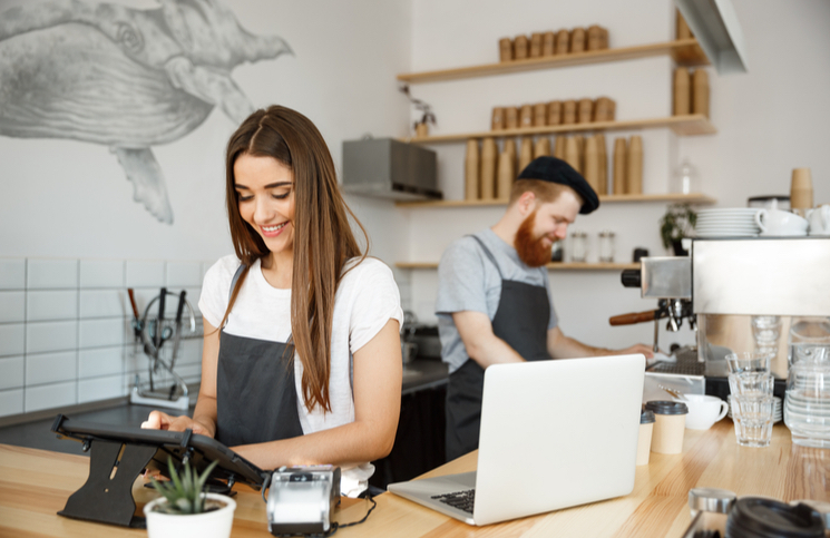 Coffee shop workers managing social media Coffee shop workers managing social media