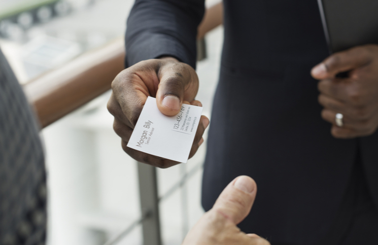 Entrepreneur handing in his business card to put his business out there