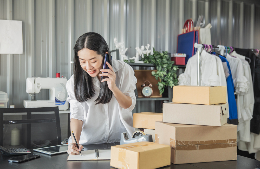 Woman entrepreneur stocking her products Woman entrepreneur stocking her products