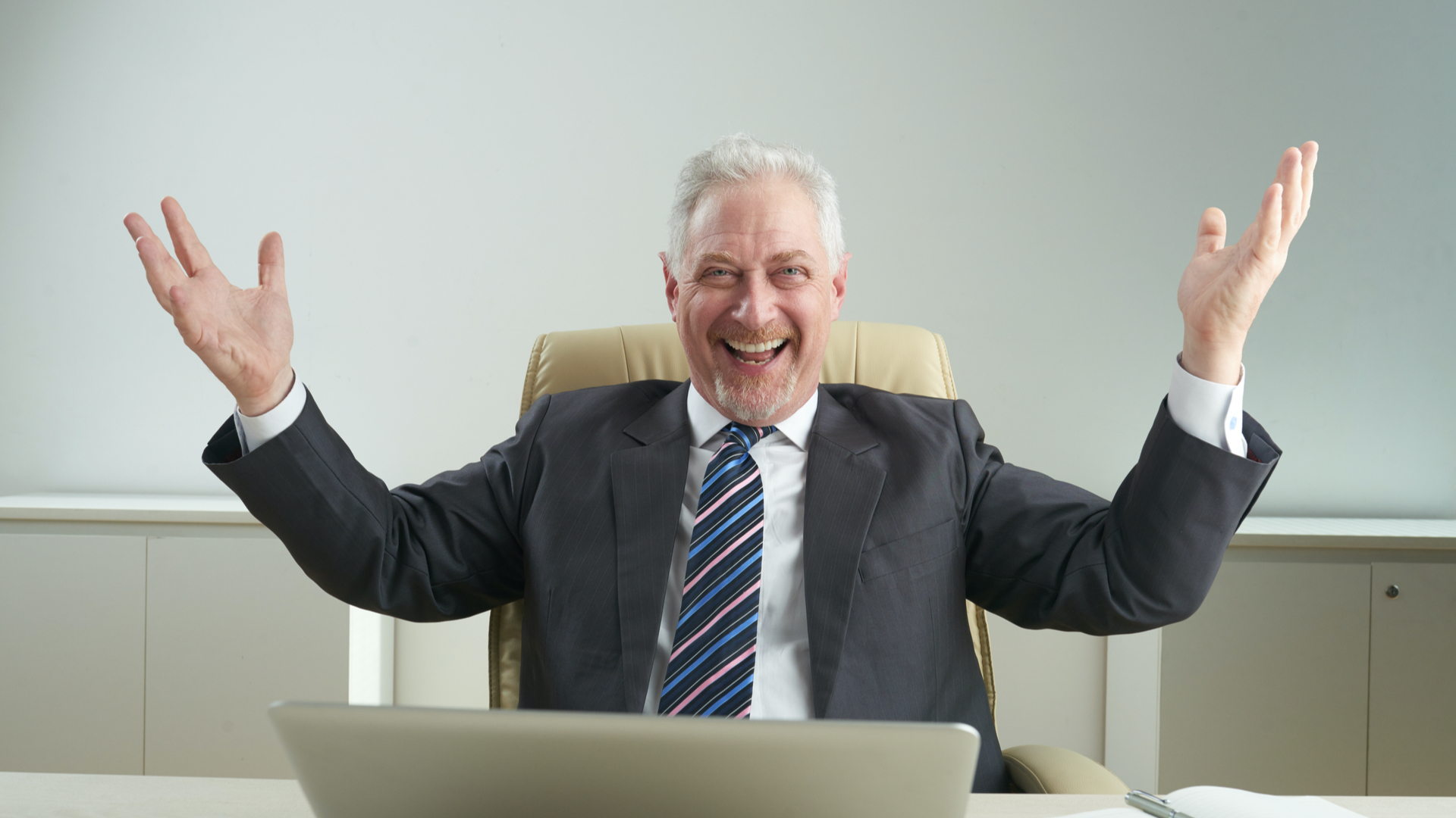 Old man smiling due to the success of his own business